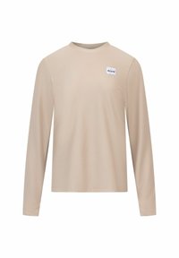Beige lange mouw shirt van textuurstof. Beschikt over een ronde halslijn en een klein wit label met "einy" op de borst.
