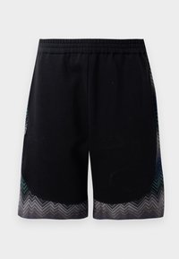 Mustad mustmed lühikesed treeningpüksid elastse vöökoha ja teal, halli ja musta värvi siksakimustriga servaga. Materjal näeb välja pehme ja kerge.