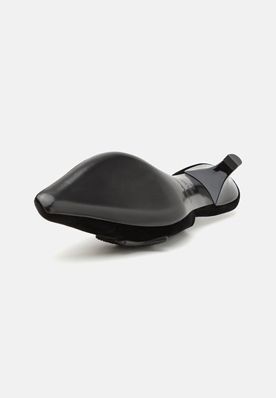 Black flat shoes with a pointed toe, sleek design, glossy material, and suede accents; features a small strap at the heel.