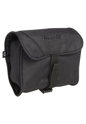 Étui de transport compact en tissu noir avec rabat sécurisé par une sangle et une boucle, logo Brandt embossé sur le rabat avant.