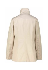 Beige jacket with a high collar, long sleeves, and a straight cut. Made of smooth fabric with minimal seams and no distinctive patterns.