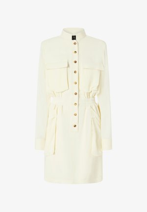 Vestito color crema con maniche lunghe, apertura frontale con bottoni, due tasche sul petto, vita elasticizzata e fianchi arricciati. Realizzato in tessuto leggero.