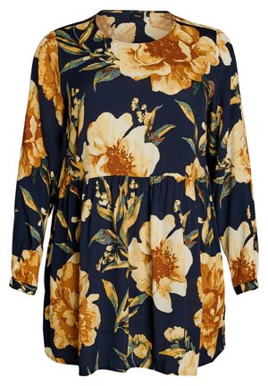 Cvetlična tunika z dolgimi rokavi v temno modri barvi, ki vsebuje velike rumene in smetanaste cvetove z zelenimi listi na teksturirani tkanini. Okrogli izrez na vratu.