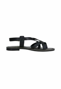 Des sandales noires avec une semelle plate, comportant des brides croisées et une bride à l'arrière. La semelle présente un détail décoratif de bord cousu.