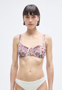 Σουτιέν με λουλουδάτο σχέδιο σε μαρόν και εκρού χρώμα, με μπανέλα, ρυθμιζόμενους ιμάντες και λεπτομέρεια στη συγκέντρωση στο κέντρο. Λείο ύφασμα.