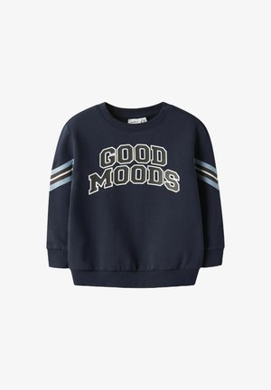 Tamsiai mėlynas džemperis su užrašu "GOOD MOODS" baltos ir smėlinės spalvos. Rankovėse yra dryžuoti akcentai šviesiai mėlynos ir rudos spalvos. Klasikinis apvalus kaklas.