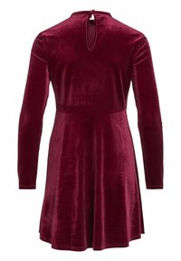 Burgundy sammet klänning med långa ärmar, figurnära liv, utsvängd kjol och nyckelhål i ryggen. Slät yta och mjuk lyster.