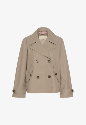 Vaažiminen bež safirivärisellä trench-manttelilla, jossa on suuri leikauskaulus, kaksi etutaskua ja ruskeat napit. Silkkinen kangas, jossa on minimaalinen rakenne.