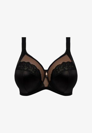 Soutien-gorge noir alliant un satin lisse et de la dentelle, avec un panneau supérieur en maille texturée et des bretelles réglables. Détail central avec une petite accent.