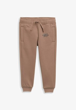 Braune Jogginghose aus weichem Stoff, mit Seitentaschen, einem elastischen Bund mit Kordelzug und einem kleinen grafischen Text auf der Vorderseite.