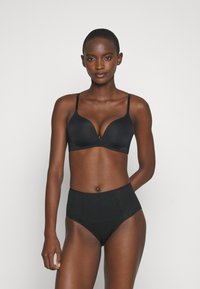 Black lingerie set featuring a smooth, plunge bra with adjustable straps and high-waisted brief with subtle texture. Both pieces are seamless.