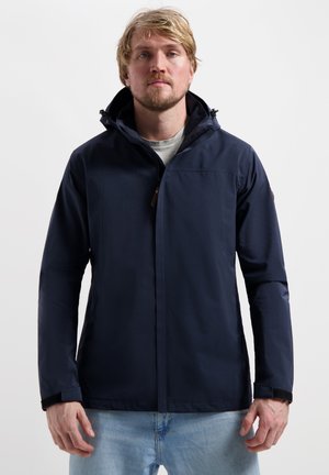 Marineblauwe waterdichte jas met hoge kraag, voorrits en verstelbare capuchon. Bevat zijzakken en elastische manchetten voor een strakke pasvorm.