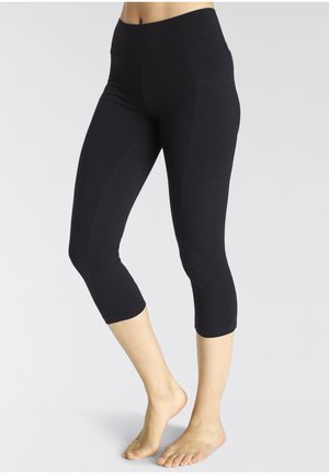 Black capri leggings with a high waistband, made of stretchy fabric, featuring a seamless design and smooth texture.