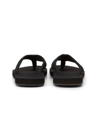 Black flip-flops with a flat sole, featuring a simple design and rubber straps. The texture is smooth, with minimal detailing on the footbed.