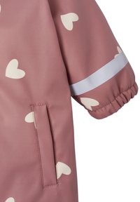 Pink waterproof jacket with white heart patterns, elastic cuffs, and a reflective accent on the sleeve. Side pocket included.