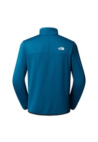 Giacca di pile blu da uomo con collo alto, maniche lunghe e un logo bianco sul retro. Tessuto liscio con una leggera lucentezza.