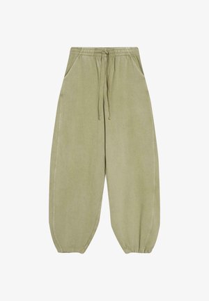 Loose light olive green sweatpants with elastic waistband, drawstring, side pockets, and elastic cuffs at ankles.