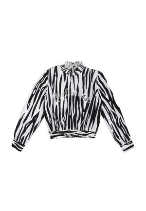 Blusa corta a strisce zebrate in bianco e nero con colletto arricciato e vita elasticizzata, caratterizzata da polsini a strisce a contrasto e un dettaglio grafico.