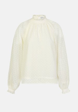 Light yellow blouse with a high neck, puffed sleeves, and ruffles at the cuffs. Textured fabric features small white polka dots throughout.