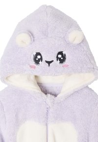 Light purple plush onesie with a hood featuring a white inner lining, bear face design, decorative ears, and a front zipper. Soft texture.