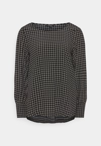 Schwarze Bluse mit langen Ärmeln, die ein geometrisches weißes Muster aufweist, runden Ausschnitt und einen leicht lockeren Schnitt hat. Glattes Material mit entspanntem Stil.