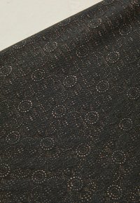 Black textured fabric featuring a pattern of small circles, with a subtle sheen and intricate, open-weave details throughout.