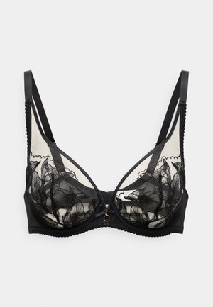 Reggiseno in pizzo nero con coppe trasparenti con motivi floreali, fascia inferiore solida, spalline regolabili e un piccolo dettaglio decorativo al centro.