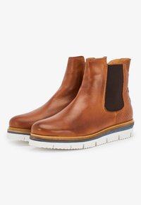 Brown leather ankle boots with elastic side panels, textured accents, and white outsole with blue trim. Smooth finish and rounded toe design.