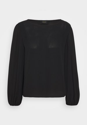 Černá dlouhá rukávová blůza se rovnými liniemi, kulatým výstřihem a elastickými manžetami. Vyrobena z hladkého, mírně průsvitného materiálu.