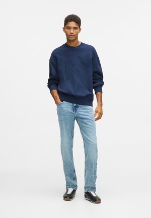 Sirgete säärtega teksad - washed mid blue