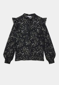 Blouse noire à motifs floraux avec des épaules volantées, des manches longues bouffantes, un décolleté en forme de clé et de délicats motifs floraux blancs et verts tout au long.