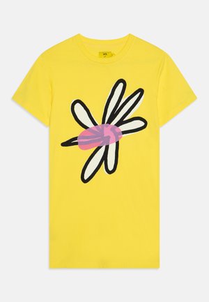 Yellow cotton t-shirt with a large stylized daisy graphic in black, white, and pink on the front. Short sleeves and a classic crew neckline.