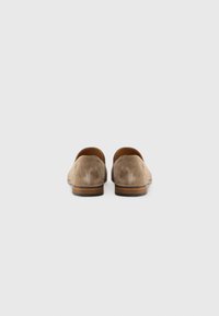 Brown suede loafers with a smooth upper, rounded heel, and a contrasting wooden sole. Textured finish with clean lines and minimal detailing.