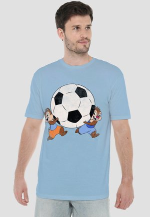 Man wearing light blue t-shirt with cartoon chipmunks pushing a large black and white soccer ball graphic.