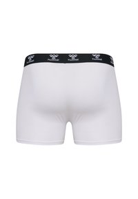 Vita boxershorts med en svart elastisk midja som har "hummel"-logotypen i vitt. Slät tyg, åtsittande design och med längd till mitten av låret.