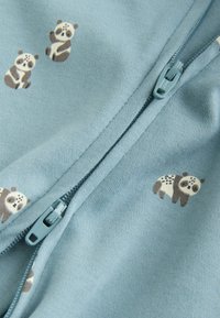 Sudadera con cremallera en azul claro, con estampados de pandas, que presenta un cierre frontal con cremallera y una tela suave al tacto.