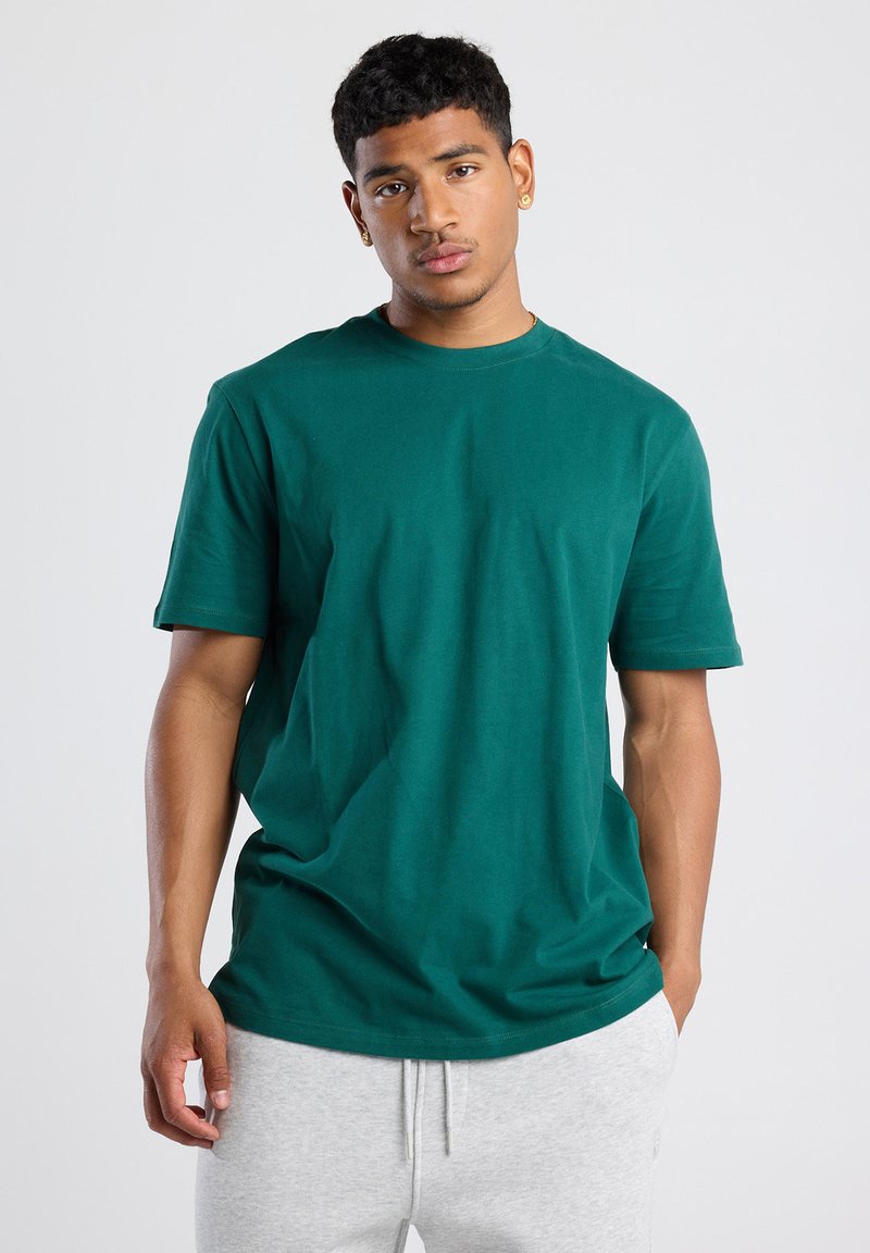 Green cotton T-shirt with a crew neckline and short sleeves, featuring a relaxed fit and smooth, even texture.