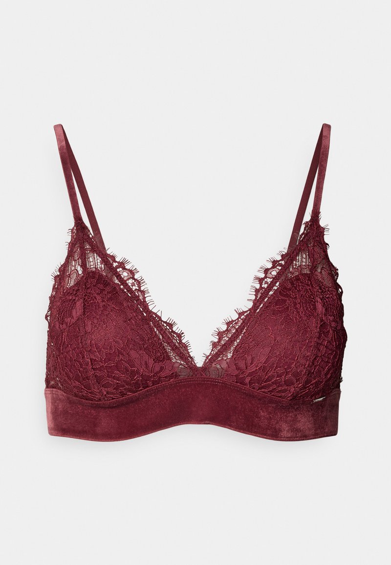 Bralette in pizzo borgogna con coppe morbide, spalline in satin regolabili e una banda liscia con una trama sottile. I bordi presentano dettagli sfrangiati.