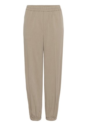 Pantalon beige ample avec taille élastique et bords aux chevilles, en tissu léger, adapté pour un style décontracté ou détente.
