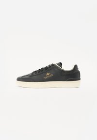 Black leather sneaker featuring a cream rubber sole, rounded toe, and gold "REPLAY" logo on the side. Textured detailing on upper.