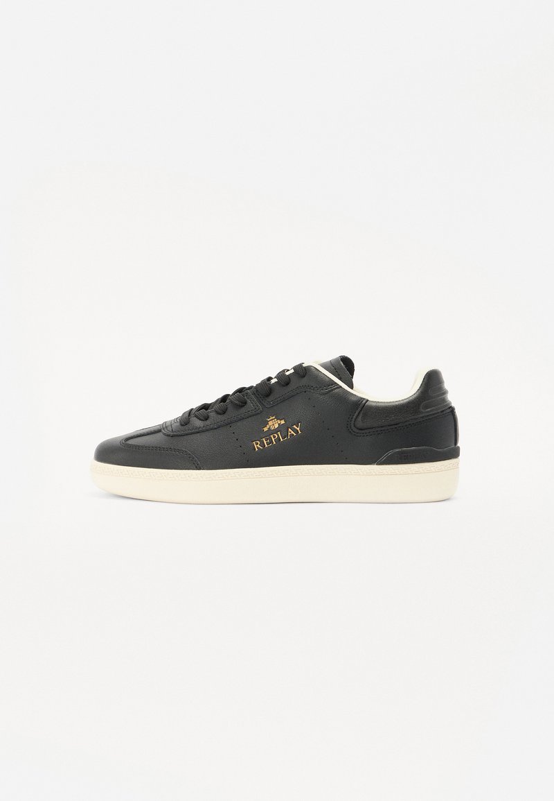 Black leather sneaker featuring a cream rubber sole, rounded toe, and gold "REPLAY" logo on the side. Textured detailing on upper.