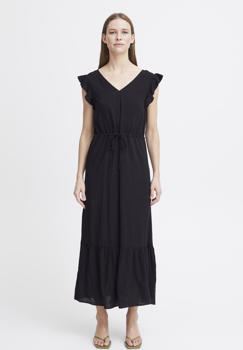 Robe maxi noire avec des manches courtes volantes, décolleté en V, taille cintrée et ourlet à volants. Fabriquée en tissu doux et léger.