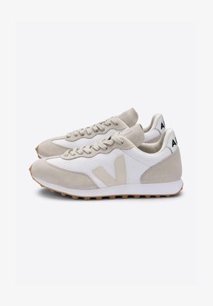 Weiße und hellgraue Sneaker mit einem Obermaterial aus Mesh, Akzenten aus Wildleder und einer strukturierten Gummisohle. Mit einem auffälligen Logo an der Ferse.
