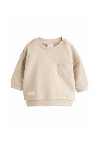 Beige színű pulóver kerek nyakkal, hosszú ujjal, mellzsebekkel és patent gombokkal a vállon. Puha pamut anyagból készült.