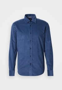Chemise bleu marine à manches longues avec boutons, col classique et une seule manchette, présentée sur un fond blanc uni.