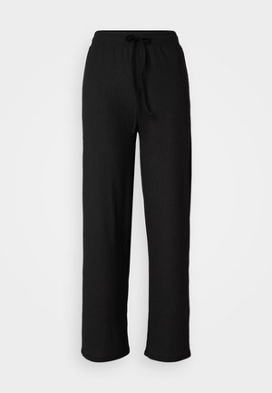 Black, loose-fitting pants with a textured fabric, drawstring waistband, and wide legs, featuring a clean, simple design.