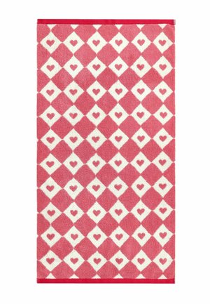 Red and white patterned rectangular rug with alternating red and white diamonds, each white diamond containing a small red heart.