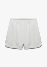 Hvide shorts lavet af et blødt, let materiale. Har en elastisk talje, sideslids og glatte, rene kanter.