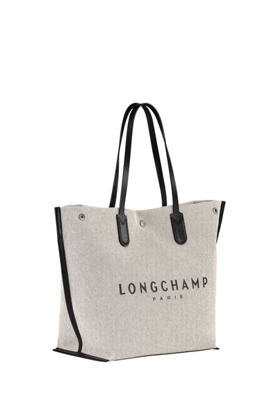 Gray fabric tote bag with black leather handles and accents, featuring "LONGCHAMP PARIS" logo printed on the front. Sturdy, rectangular shape.