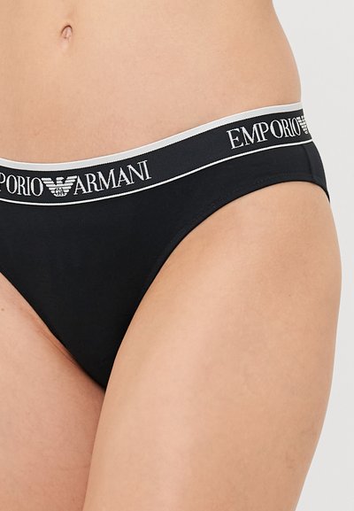 Black bikini bottom featuring a wide waistband with "Emporio Armani" logo and a contrasting gray line. Simple, smooth fabric with minimal coverage.
